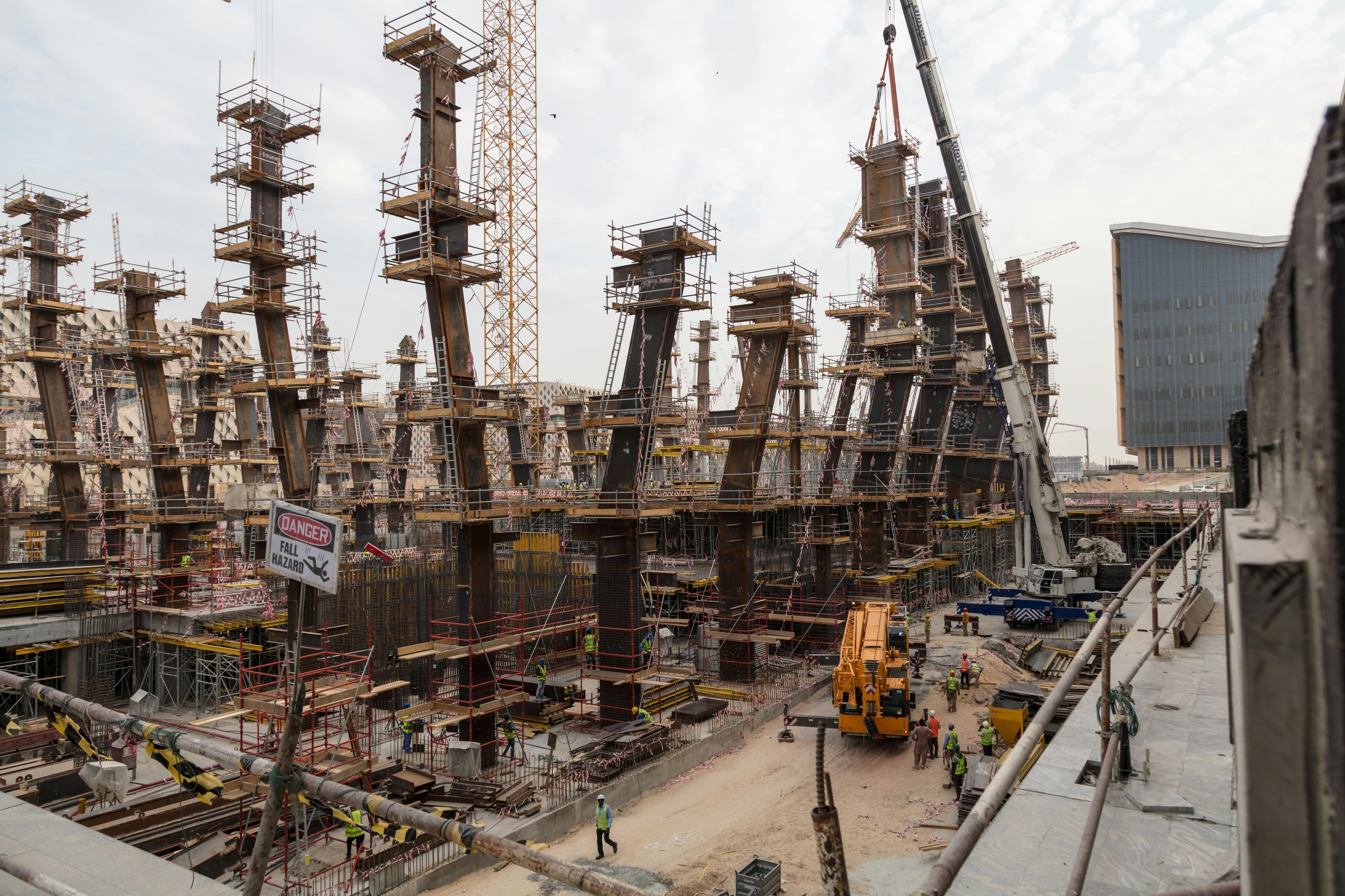 Construction crane lifting materials at an industrial site representing international projects